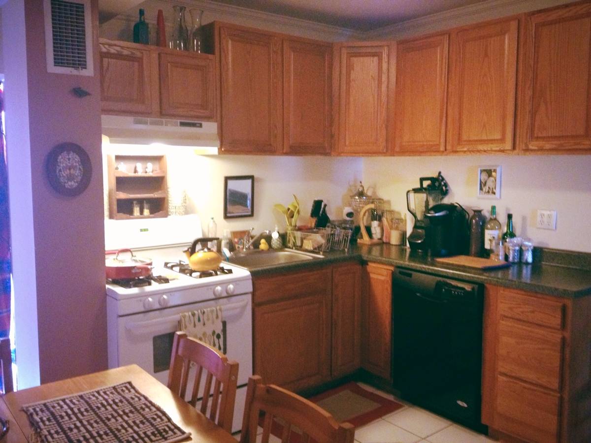 Dark rental property kitchen before professional photo enhancement service - poor lighting and unappealing appearance